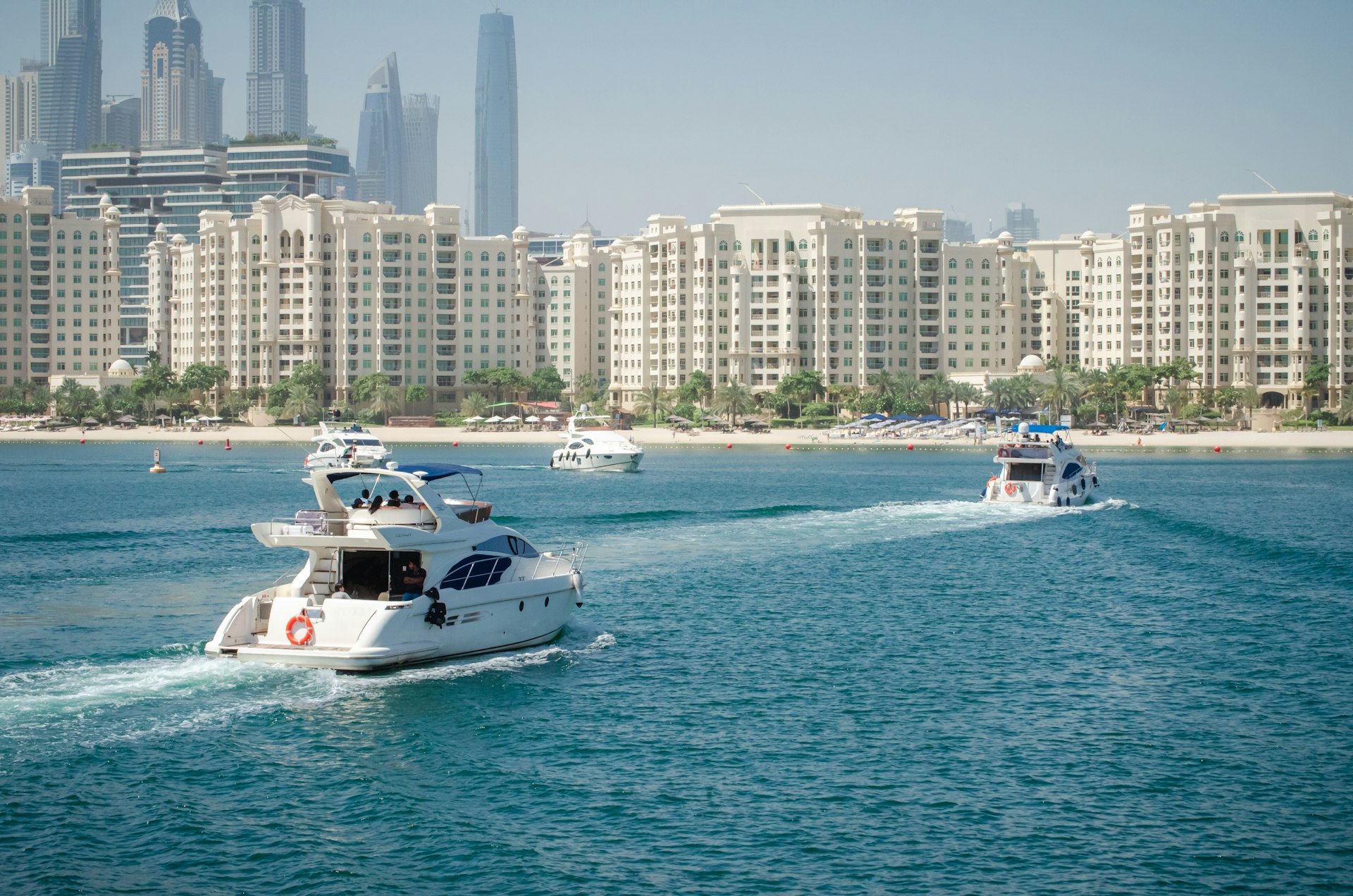 a group of boats in the water near a city